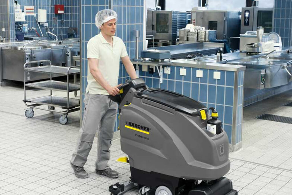 B-40-W scrubber being used by man in restaurant kitchen