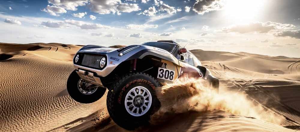 Car on sand dunes at the Dakar Rally