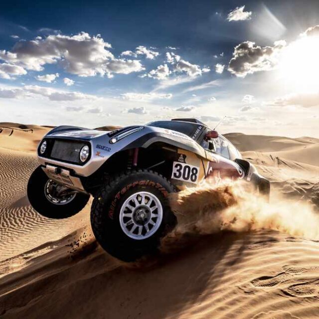 Car on sand dunes at the Dakar Rally