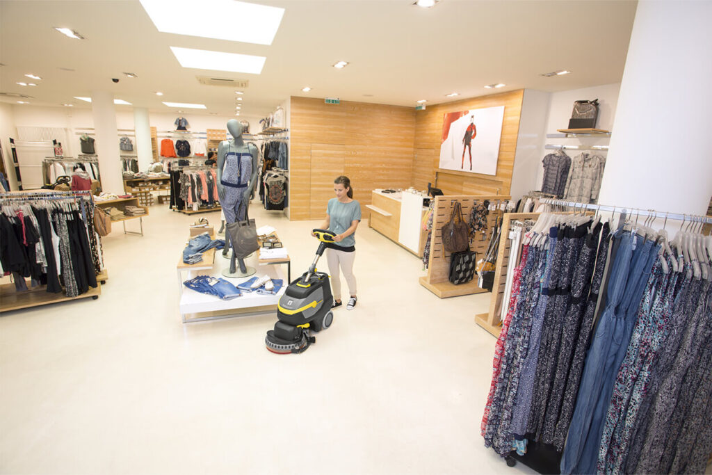 Woman using BD 38/12 Scrubber in Retail Shop