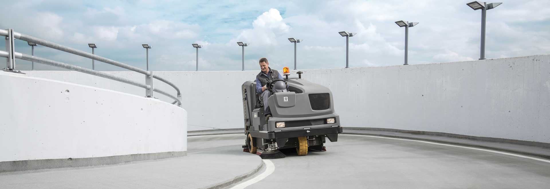 Ride on sweeper cleaning tarmac