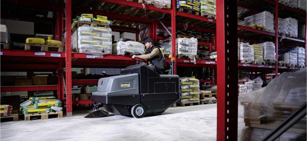 KM 105/180 battery floor sweeper in a warehouse