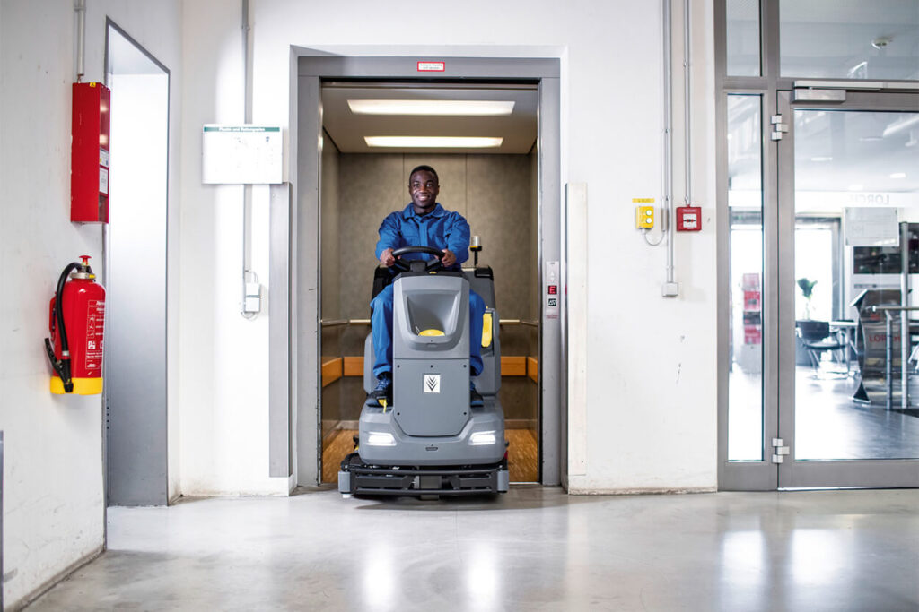 B110 R ride on floor scrubber in a lift