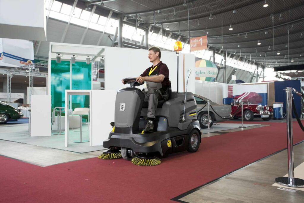 KM 90 60 battery powered ride on scrubber dryer at a car exhibition